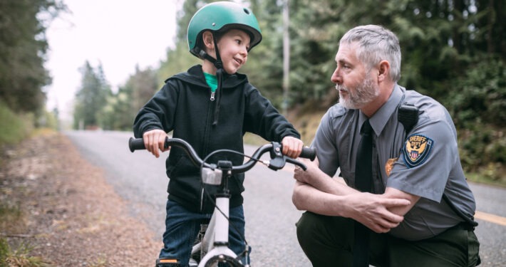 Police Officer Talking to Child on Bike